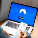 Laptop displaying a VPN connection used by a digital nomad working remotely