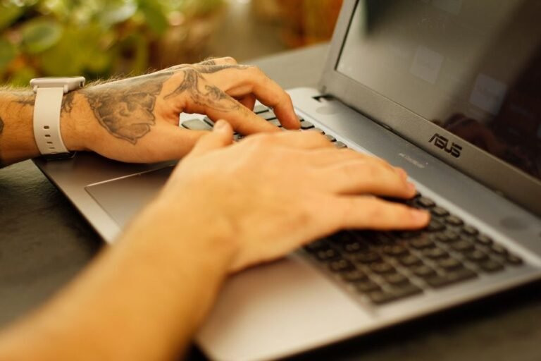 Writer using an AI writing assistant on a laptop