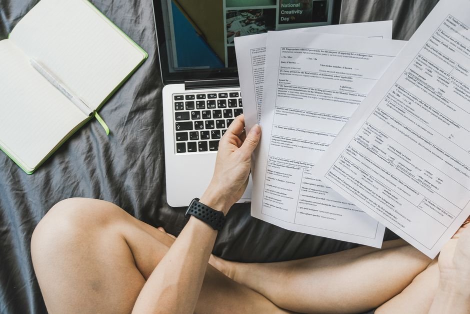 Freelancer reviewing documents on a laptop while making a quarterly estimated tax payment