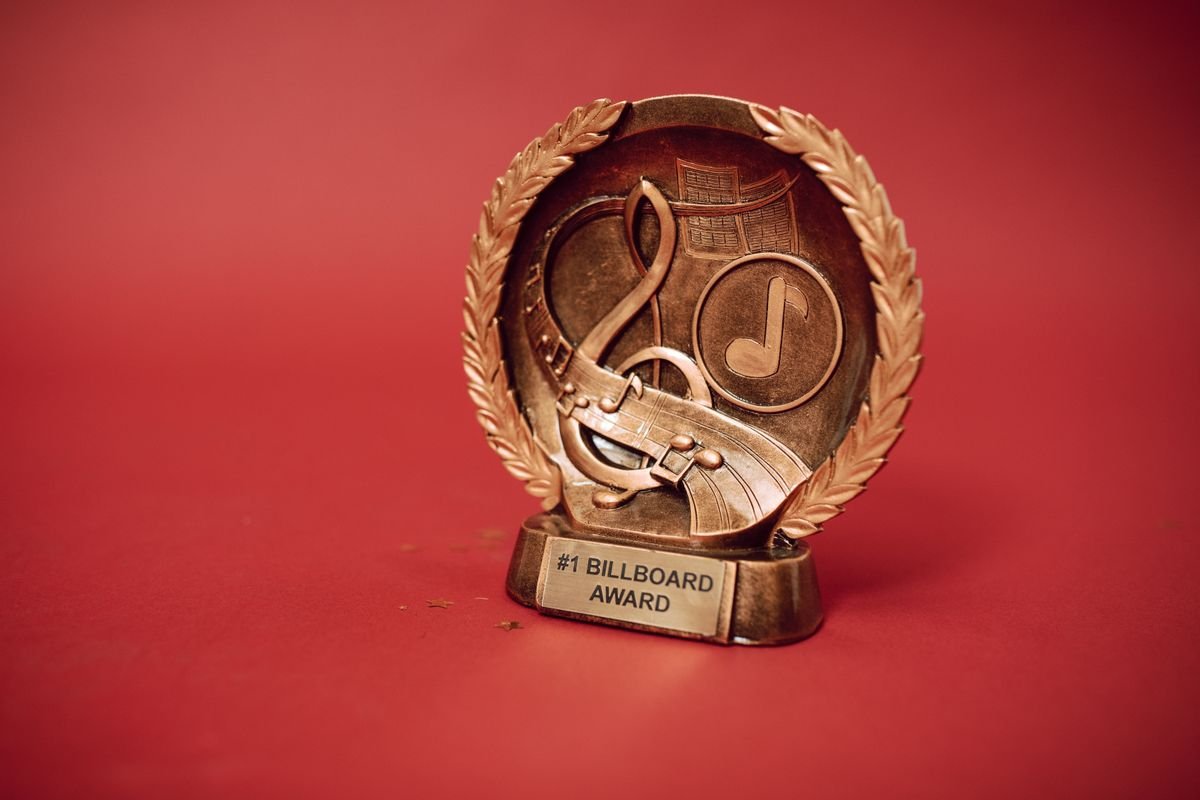 Close-up of a music industry award trophy representing a Billboard chart milestone