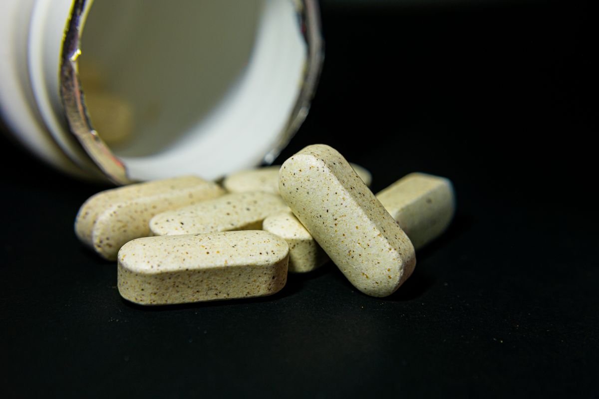 Close-up of white capsule supplement pills