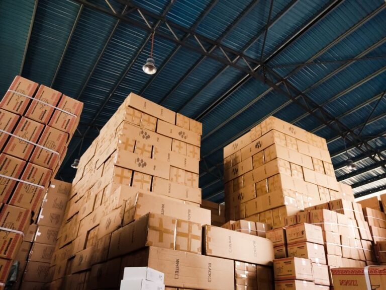 Stacked cardboard boxes in a warehouse, representing international package forwarding and consolidation