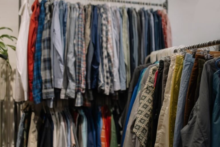 Racks of secondhand clothing sorted for resale, representing apps used to sell used clothes online