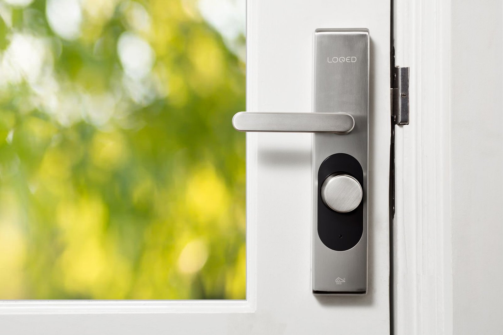 Sleek smart lock installed on a white apartment door
