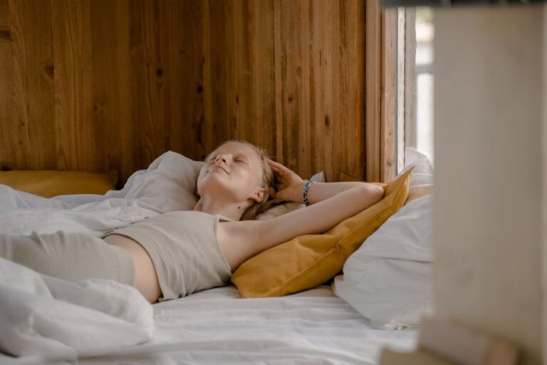 Woman waking up in a cozy bedroom in the early morning hours