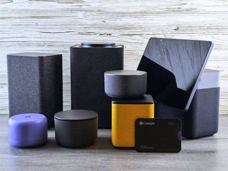 Silhouette of modern smart speakers on a wooden surface