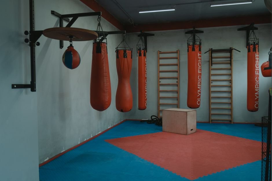 Boxing gym with hanging punching bags, representing the boxing coach setting in the drama