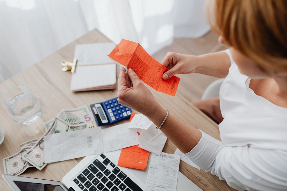 Calculator and receipts representing a budget review
