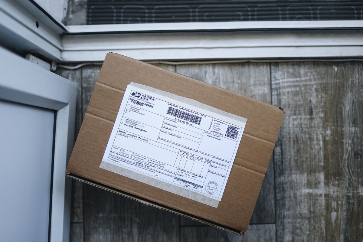 Cardboard shipping box with a label, ready to be sent for a card grading submission return