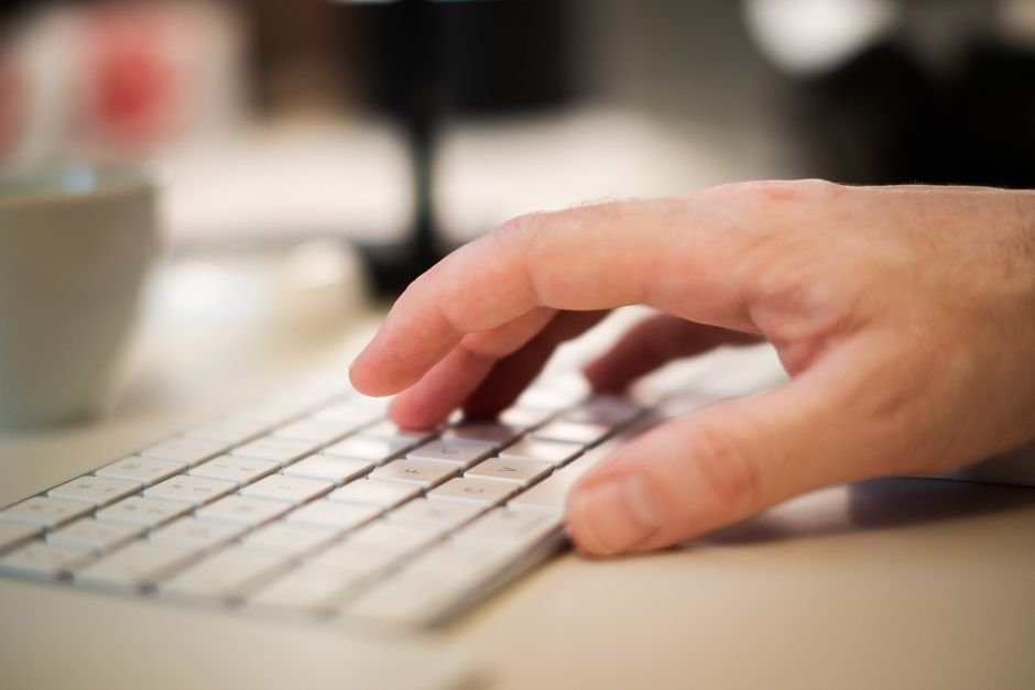 Close-up of hands checking Windows 11 taskbar settings to restore the missing Copilot icon