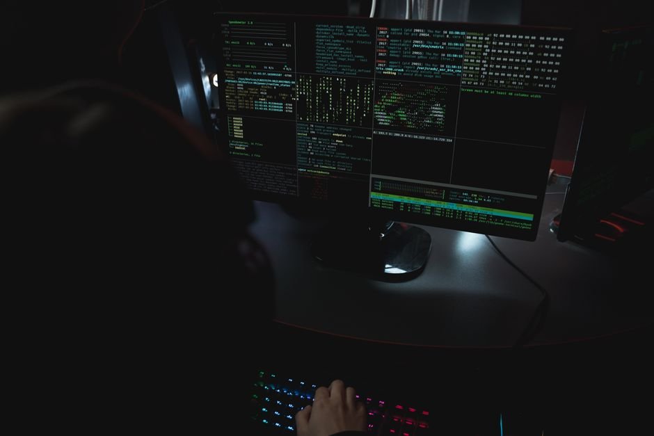 Dark control room with multiple monitors tracking cybersecurity data, representing crypto hack monitoring in 2026