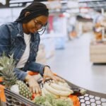 Woman shopping for groceries with a cart, representing an Instacart shopper batch