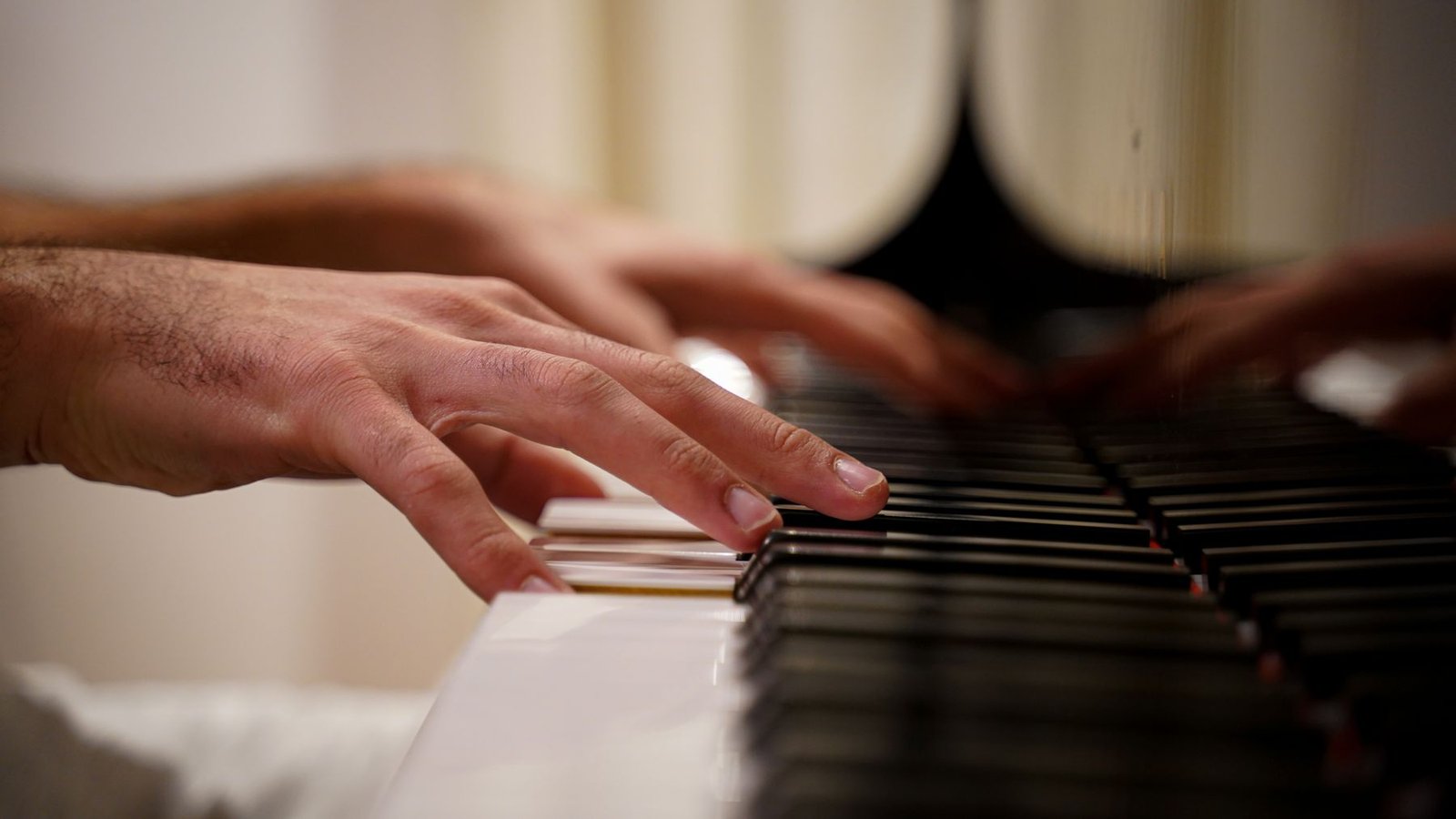 Close-up of hands playing piano keys, concept image for a music school rivalry drama