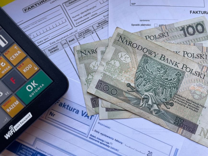 Calculator and invoice paperwork used to compare freelance platform fees