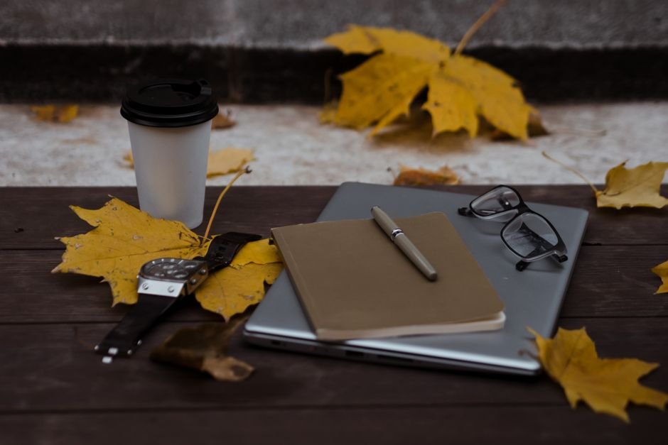 Freelance writer working on a laptop with coffee at a home desk