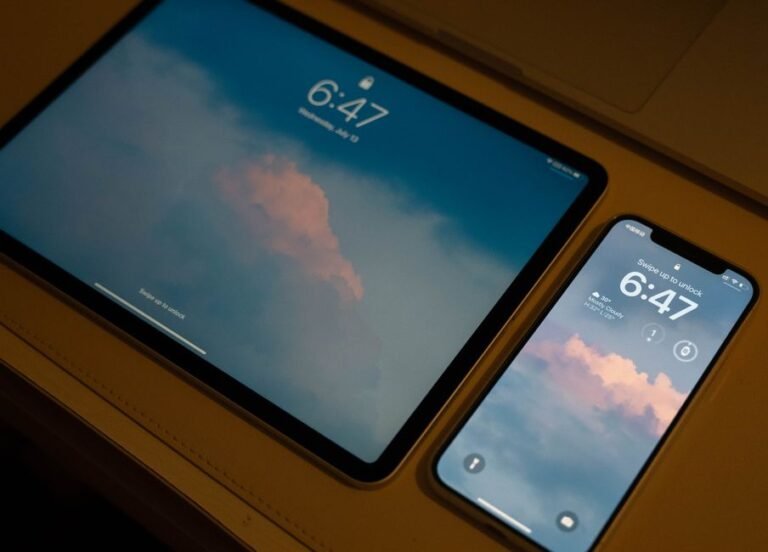 Smartphone and tablet showing matching lock screens, representing devices staying in sync