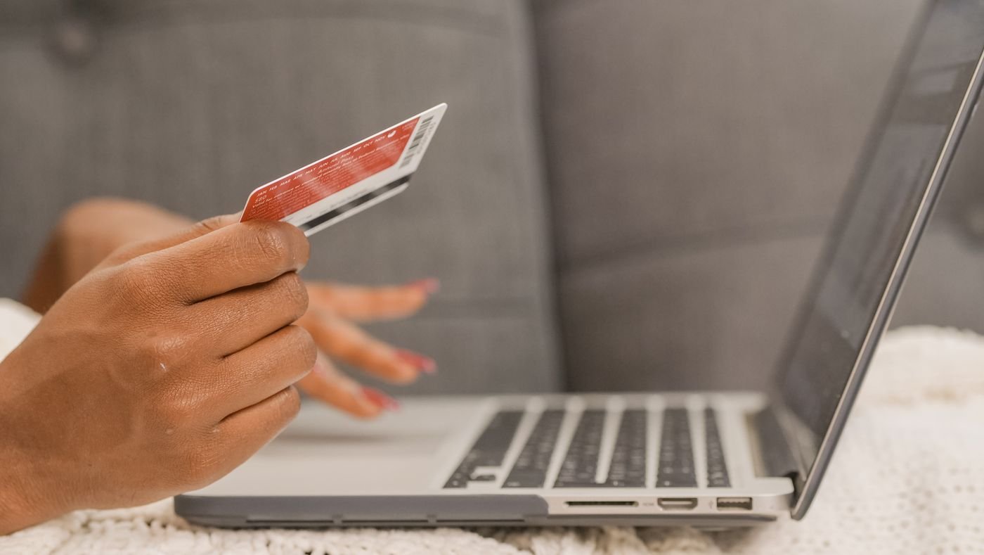 Close-up of a credit card and laptop checkout screen during an online purchase