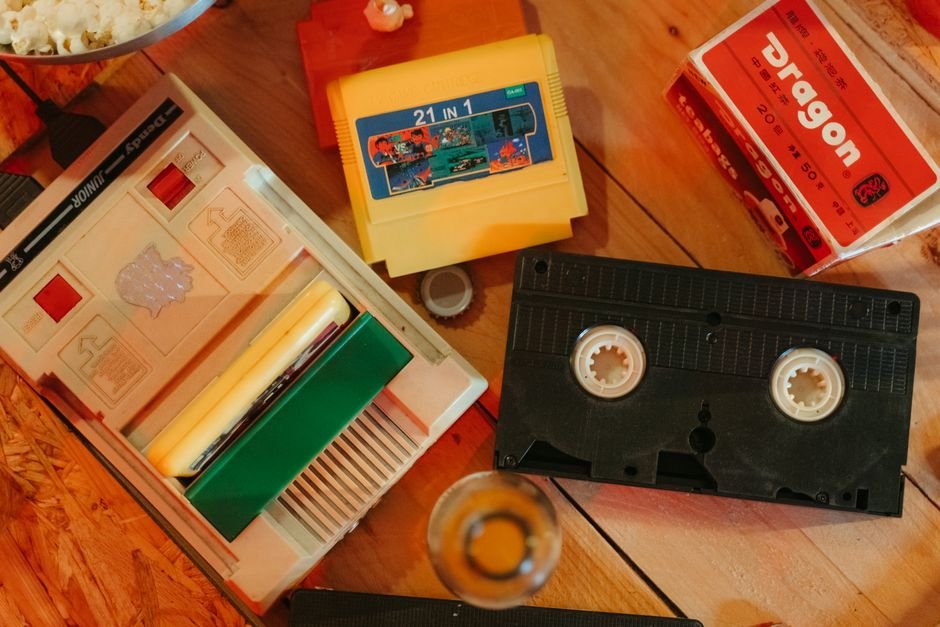 Vintage gaming console with cartridges on a wooden surface