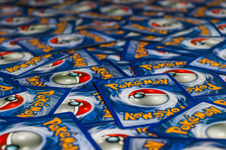 Colorful array of Pokemon trading cards fanned out, representing the Ascended Heroes set