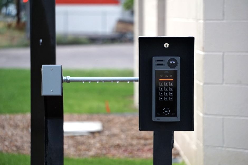 Video doorbell camera mounted beside a front door, representing a Ring Protect subscription camera