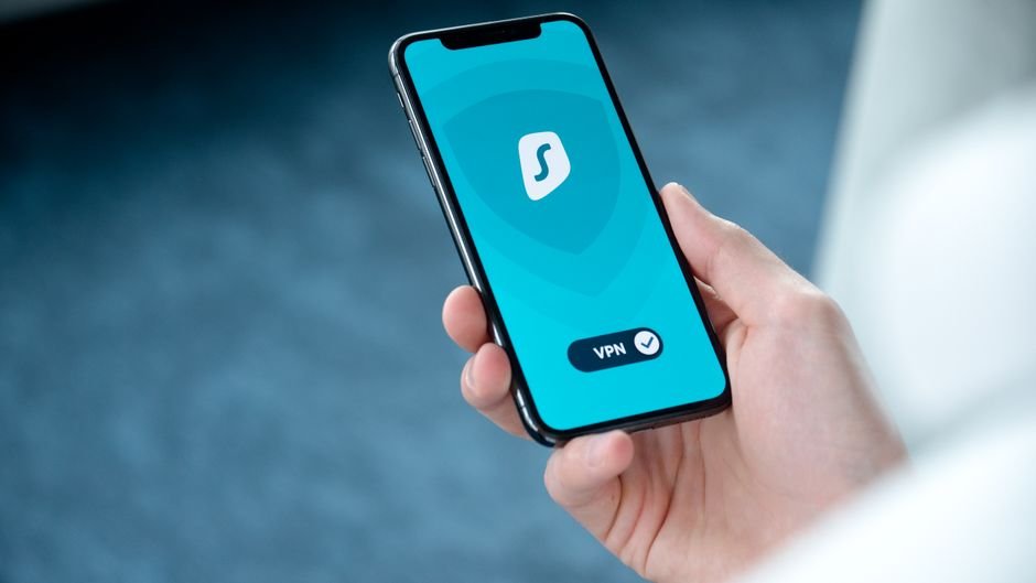 Person checking a home security app on a smartphone, representing managing a Ring Protect plan