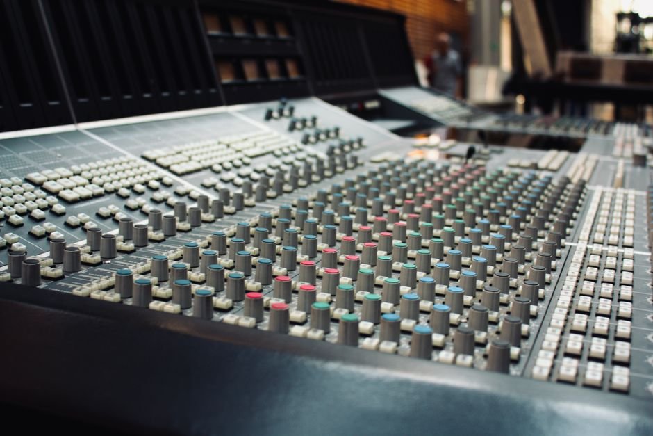 Professional audio mixing console in a recording studio, representing in-house album production