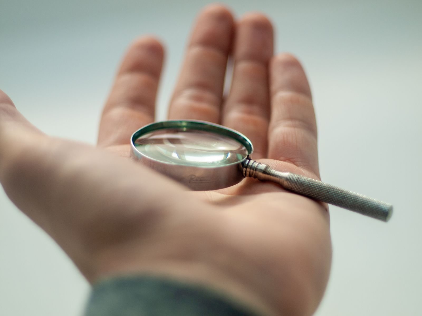 Magnifying glass used to inspect a card surface and edges for grading condition