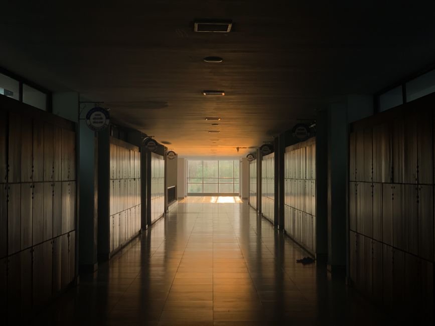 Empty school hallway representing the education-system setting of the drama