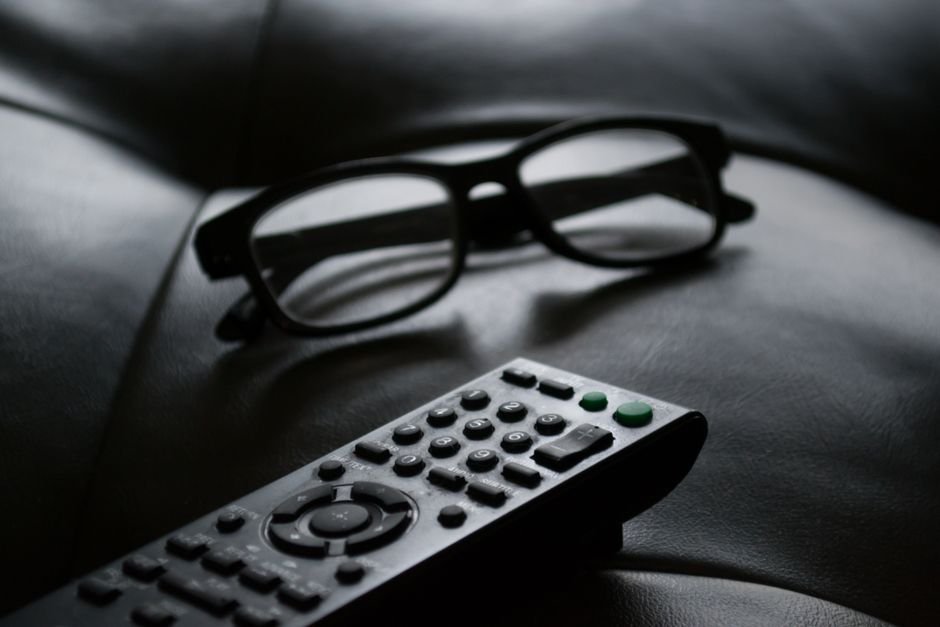 Person watching a tense drama series at night in a dark living room
