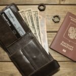 Leather wallet with cash and passport representing a digital nomad international banking setup