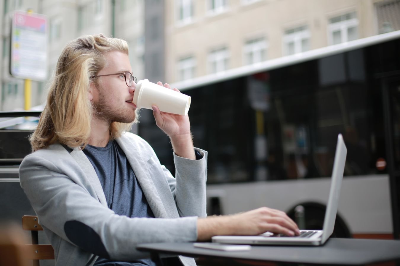 Remote worker using a laptop outdoors while managing finances abroad