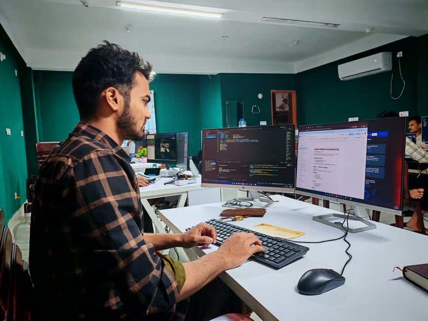 Software developer coding on a laptop representing AI coding model performance