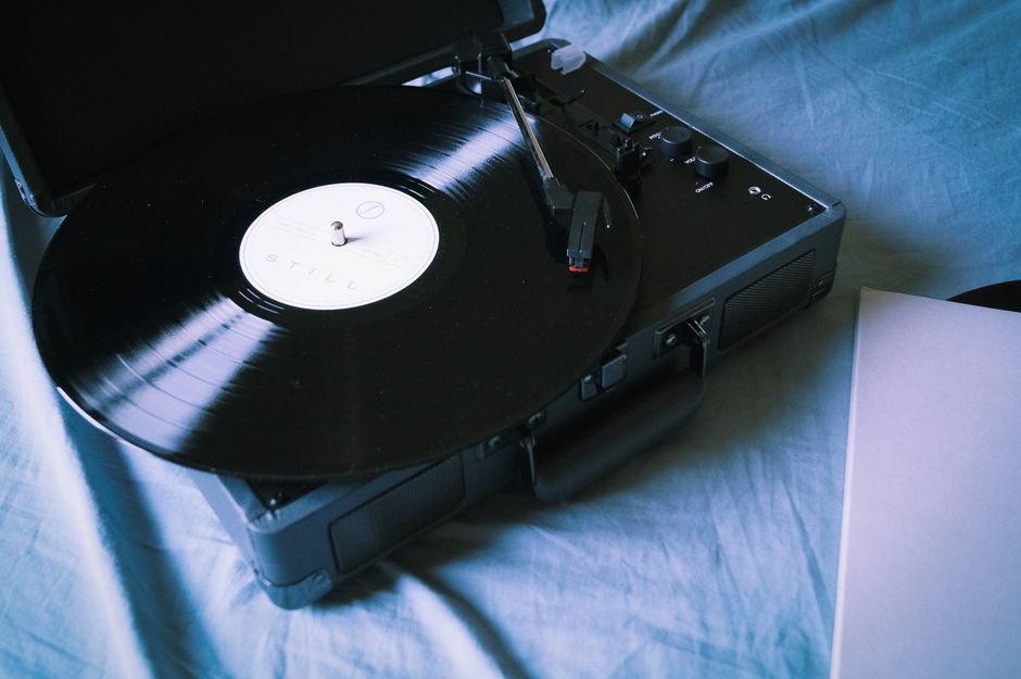 Vinyl record spinning on a turntable, representing a new solo music release