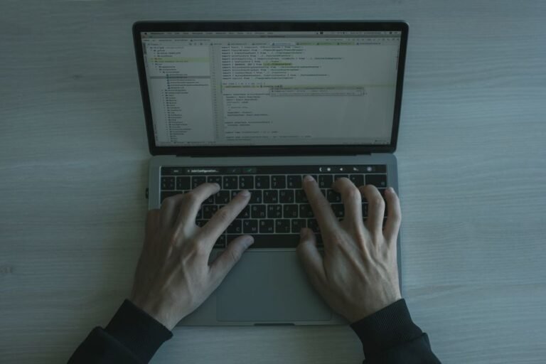 Laptop screen showing a code editor and terminal, representing an AI coding agent session