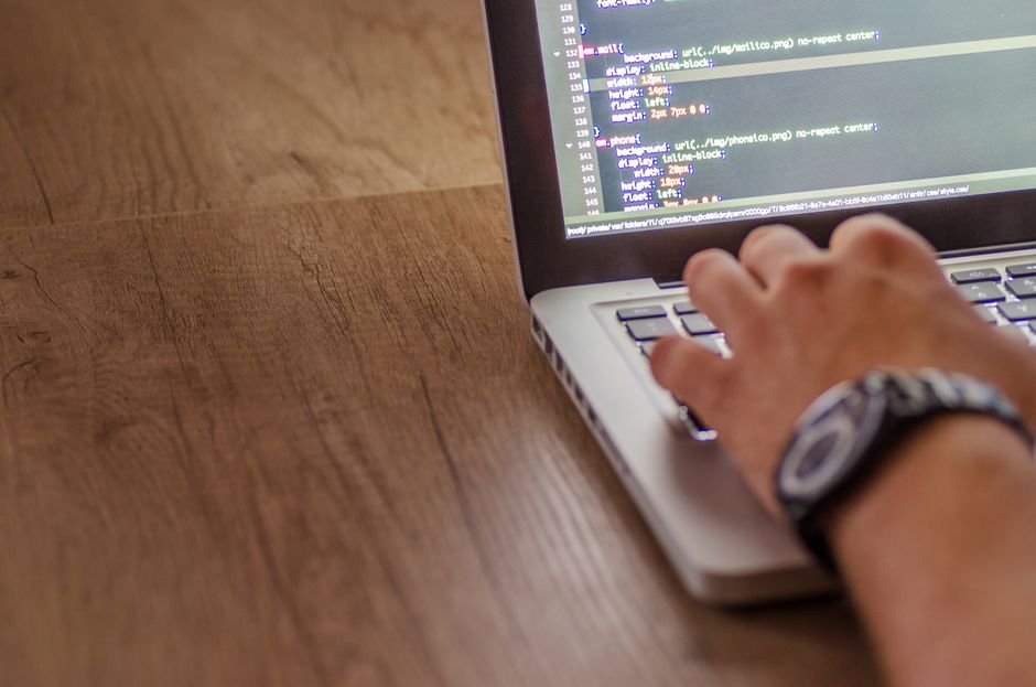 Developer writing code on a laptop, comparing AI model output