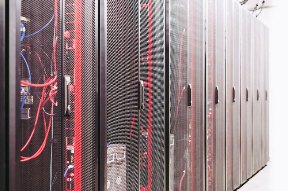 Rows of data center server racks representing AI model compute infrastructure