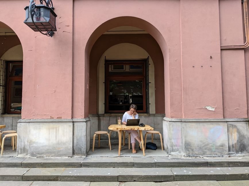 Digital nomad working on a laptop at a cafe in Europe