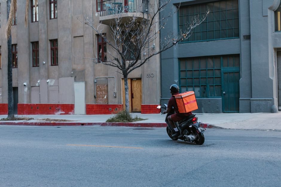 Delivery driver on a scooter representing gig economy delivery work like DoorDash