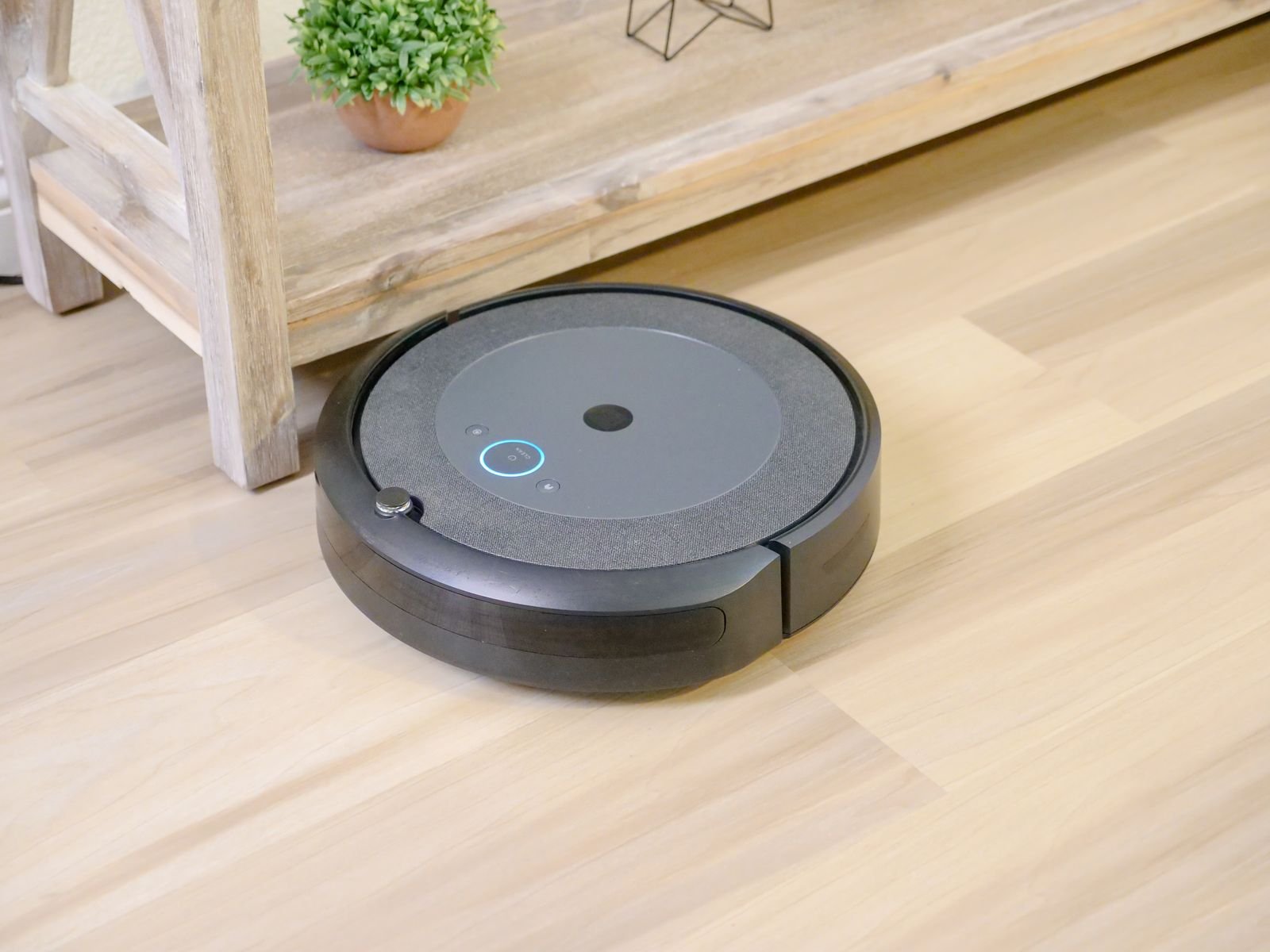 Modern living room floor being cleaned by a robot vacuum