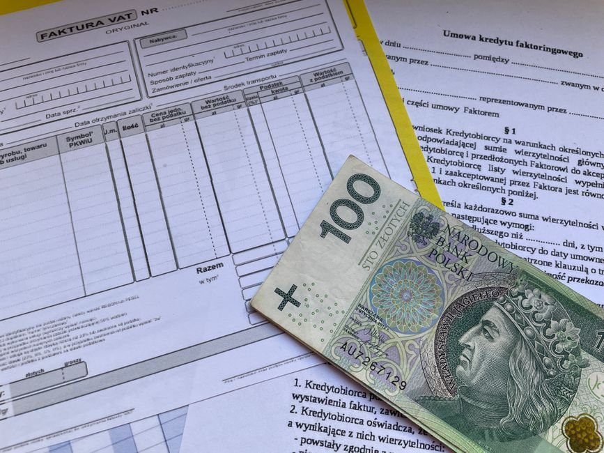 Freelancer reviewing invoice and contract paperwork