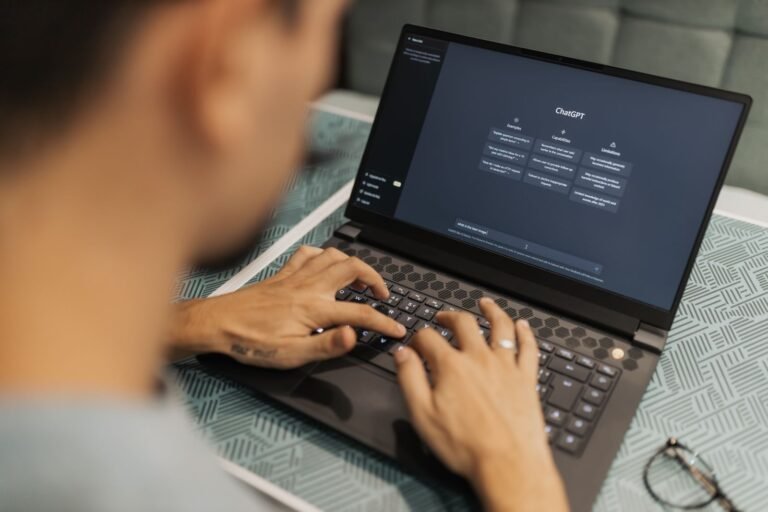 Person using a laptop with ChatGPT open, representing the decision to upgrade to GPT-6 Astra on Plus or Pro
