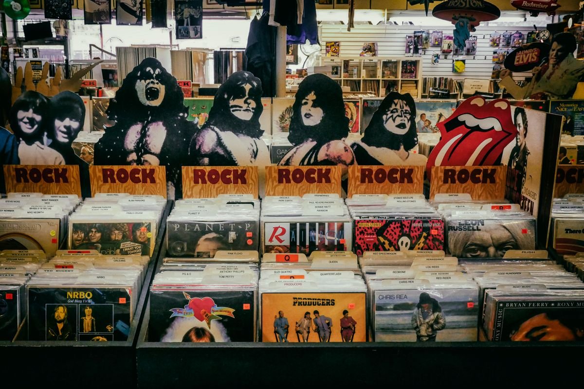 Shelves of physical album and vinyl record packaging in a music store