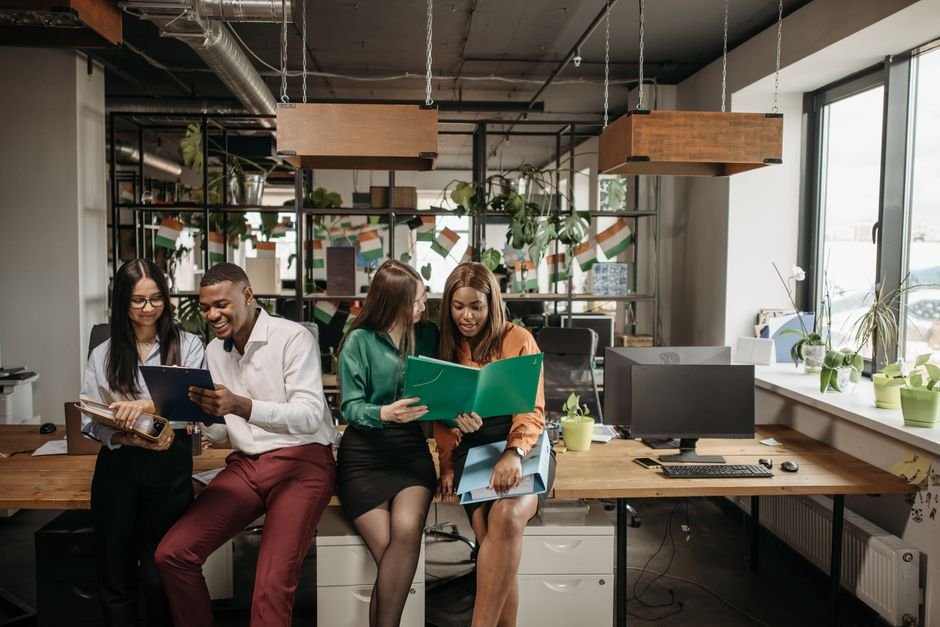 Coworkers talking together in a bright office environment