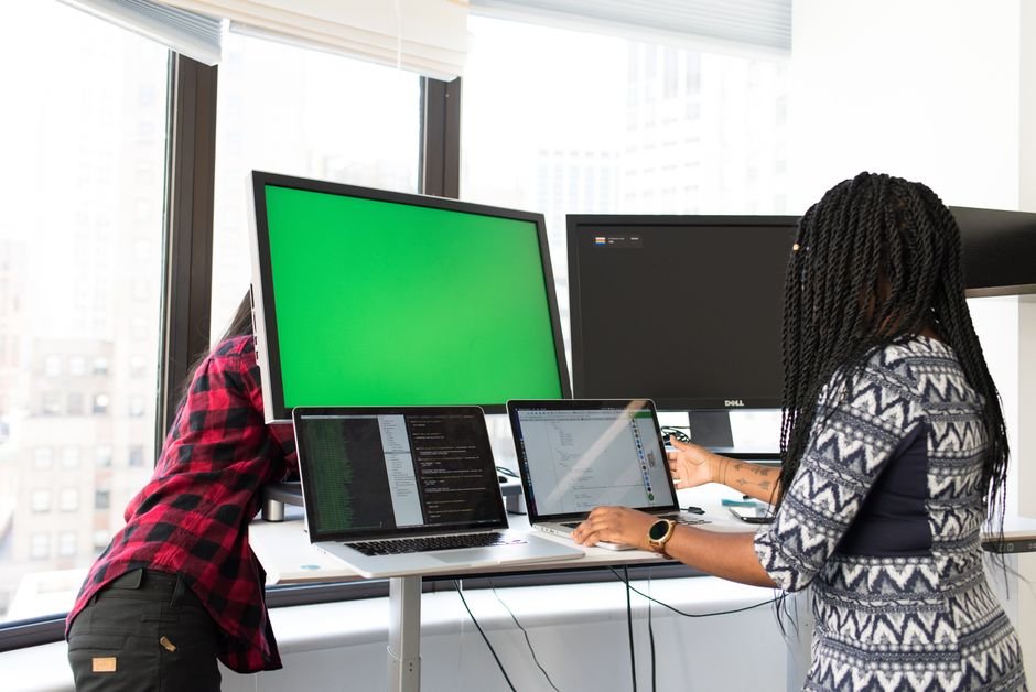 Person using a laptop with multiple collaboration and project management tools open