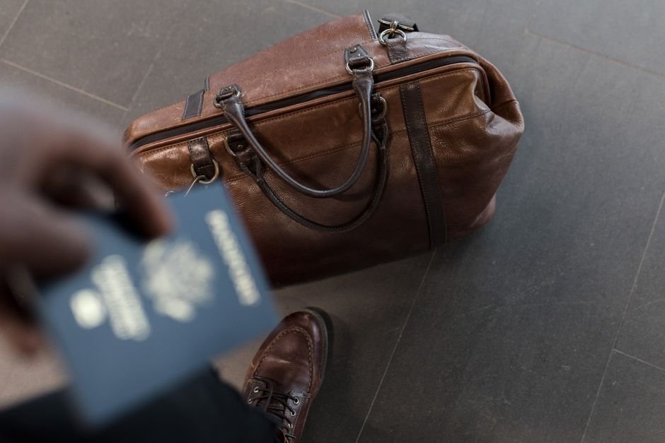 Traveler holding a passport at an airport