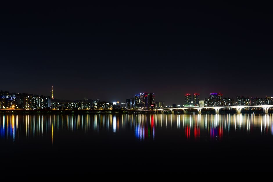 Seoul skyline reflected over the Han River at night, representing the setting behind many upcoming K-dramas