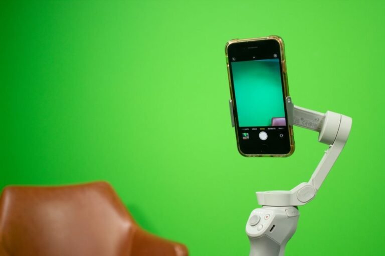 Smartphone mounted on a stabilizer in front of a green screen, representing UGC content creation as a side hustle
