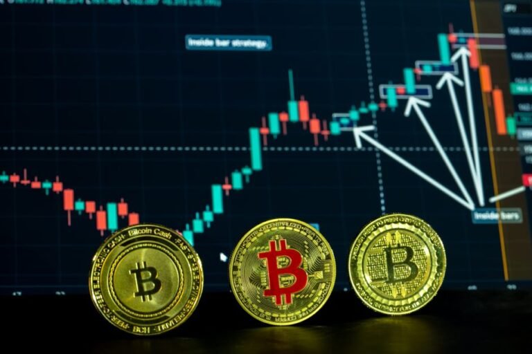 Bitcoin coins in front of a trading graph