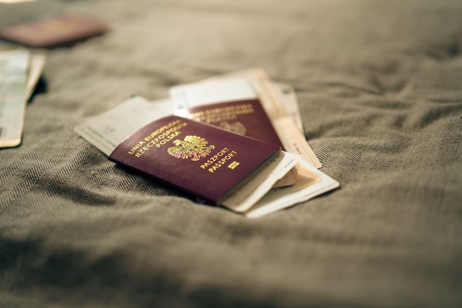 Passport and travel documents laid out, representing the papers a remote worker should carry when entering Canada