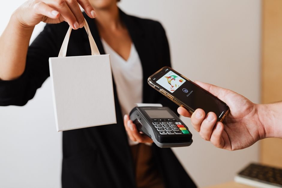 Person paying by smartphone at a payment terminal